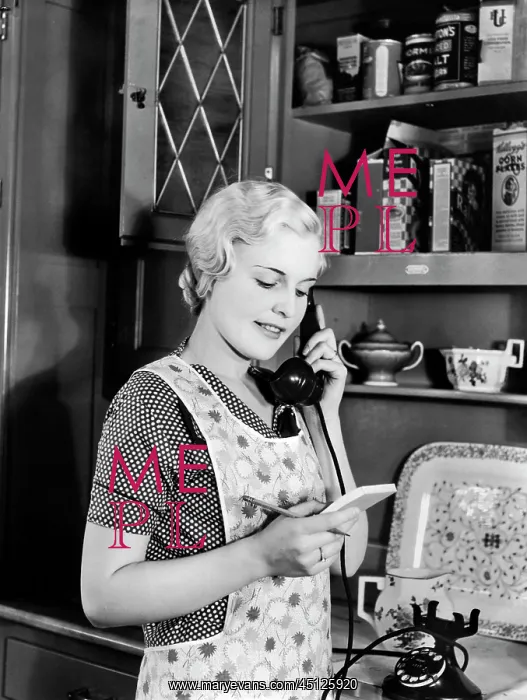 : Woman Homemaker in Apron Standing in Kitchen Talking : Woman Homemaker in Apron Standing in Kitchen Talking