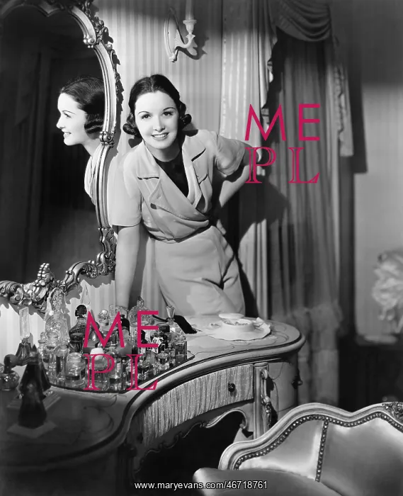  : Woman leaning on her vanity table