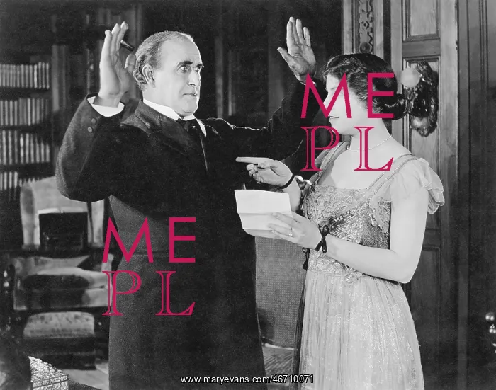  : Woman with a letter in her hand pointing at a man
