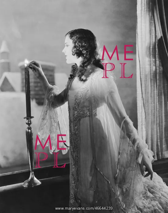 : Woman lighting candle on winter evening : Woman lighting candle on winter evening