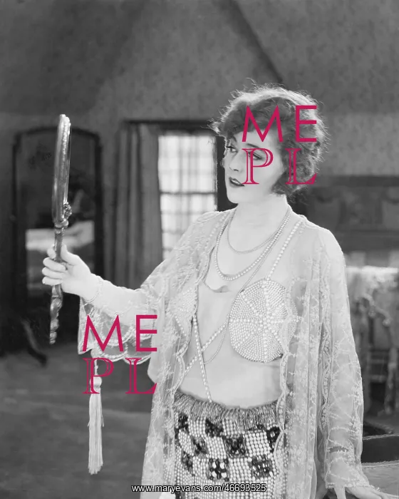  : Woman looking into a hand mirror