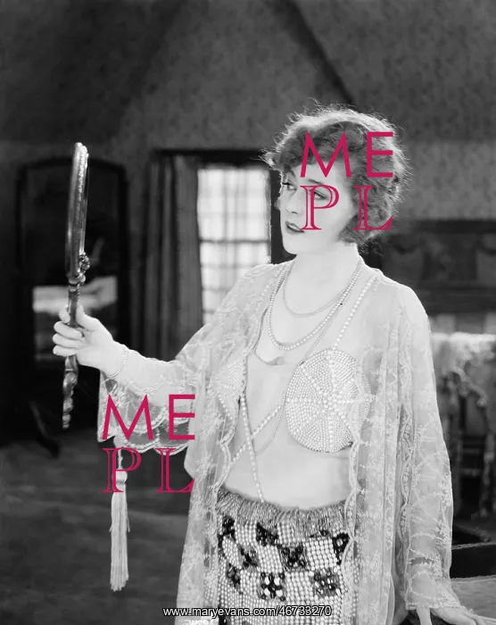 : Woman looking in hand mirror : Woman looking in hand mirror