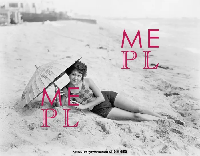 : Woman lying at the beach with a sun umbrella : Woman lying at the beach with a sun umbrella