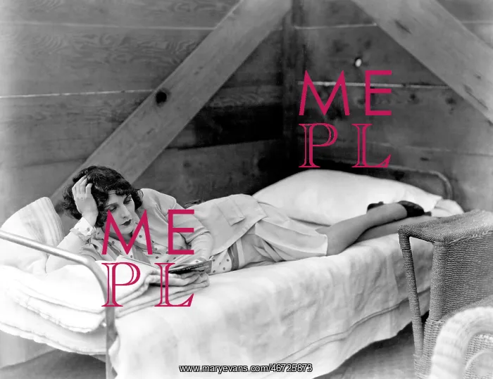  : Woman lying on cot reading