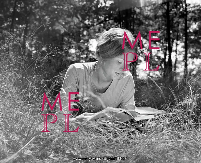  : Woman lying in a field reading a book