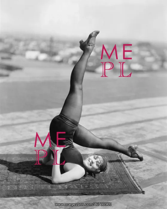 : Woman lying on a rug doing her exercise : Woman lying on a rug doing her exercise
