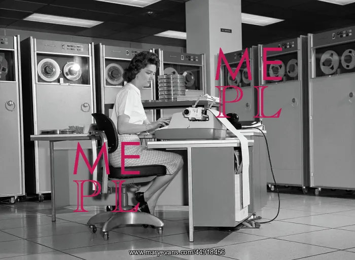: Woman in mainframe computer room surrounded by : Woman in mainframe computer room surrounded by