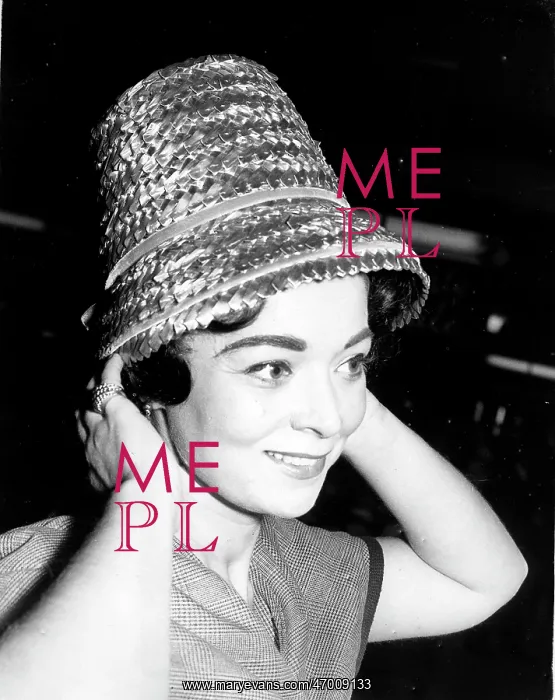 : Woman modeling straw hat : Woman modeling straw hat