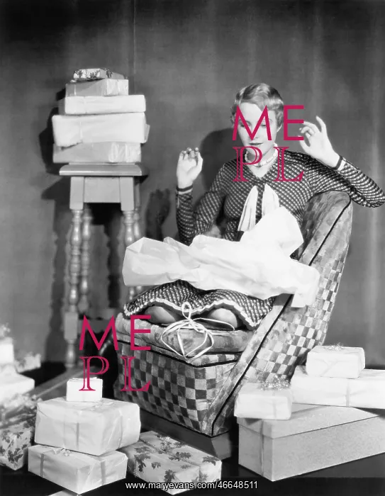 : Woman opening gifts : Woman opening gifts