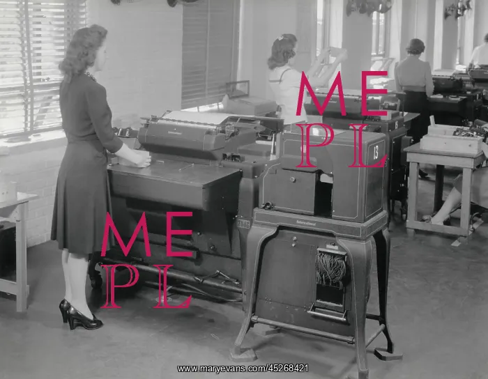 : A woman operates one of 12 IBM computers in use : A woman operates one of 12 IBM computers in use