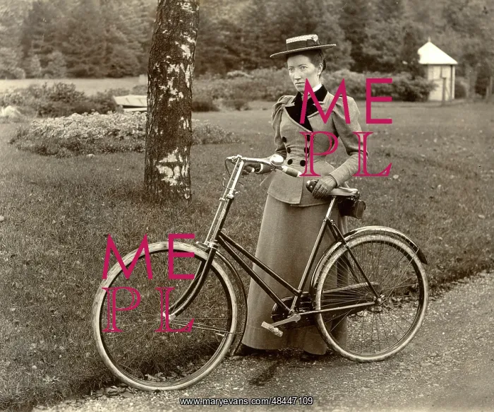  : Woman in a park with her bicycle