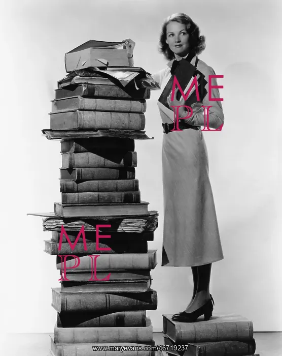 : Woman with pile of large books : Woman with pile of large books