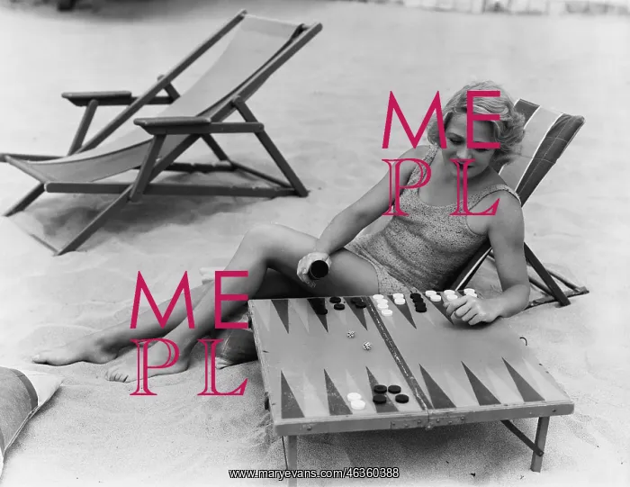 : Woman playing backgammon on beach : Woman playing backgammon on beach