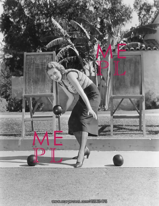 : Woman playing bocce outdoors : Woman playing bocce outdoors