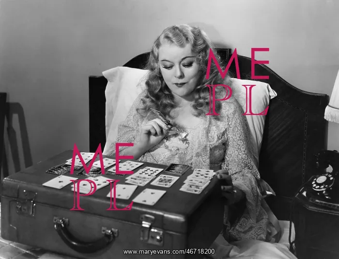 : Woman playing cards in bed : Woman playing cards in bed