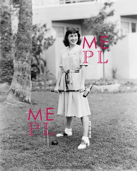  : Woman playing croquet in the yard