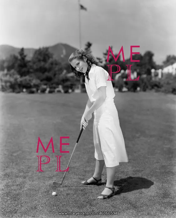: Woman playing golf on a golf course : Woman playing golf on a golf course