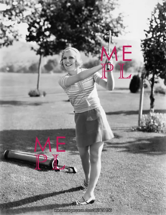 : Woman playing golf on a golf course : Woman playing golf on a golf course