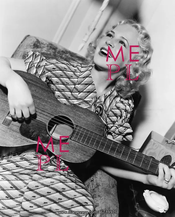 : Woman playing guitar and singing : Woman playing guitar and singing
