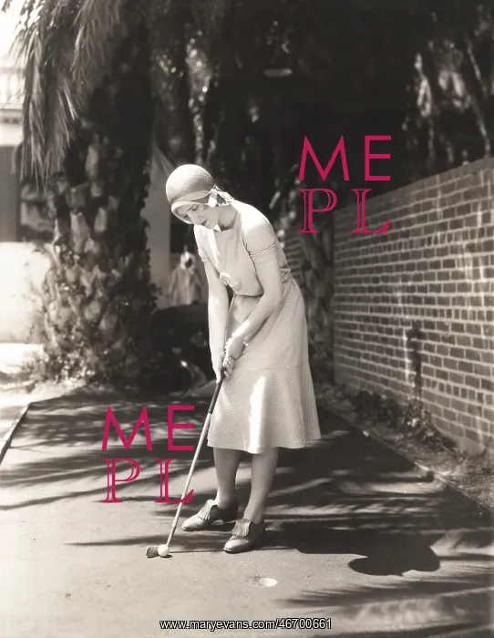 : Woman playing miniature golf : Woman playing miniature golf