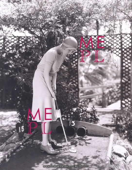: Woman playing miniature golf : Woman playing miniature golf