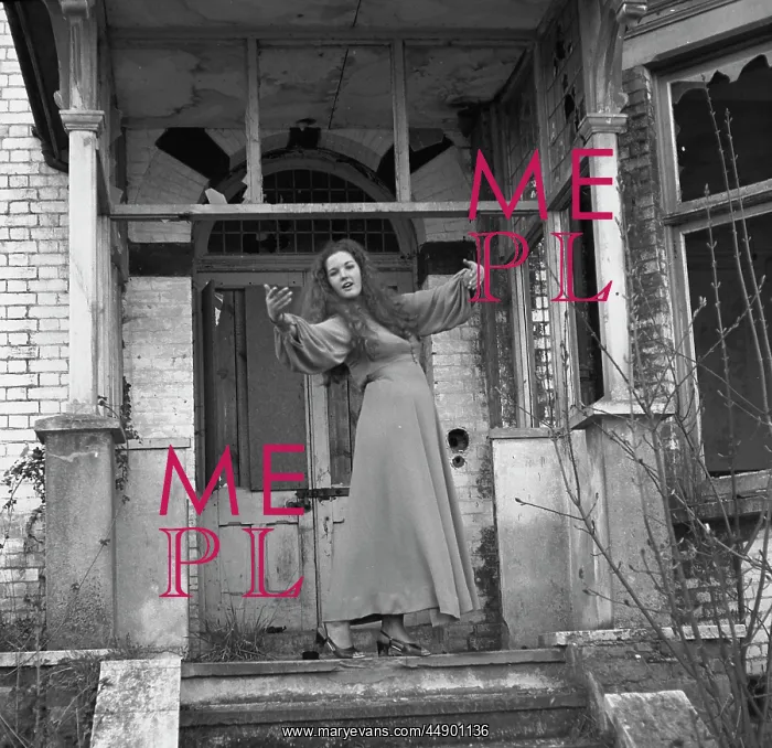 : Woman posing in front of a derelict house : Woman posing in front of a derelict house