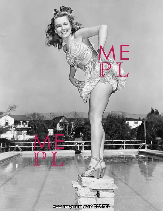 : Woman posing on top of a pillar next to a swimming pool : Woman posing on top of a pillar next to a swimming pool