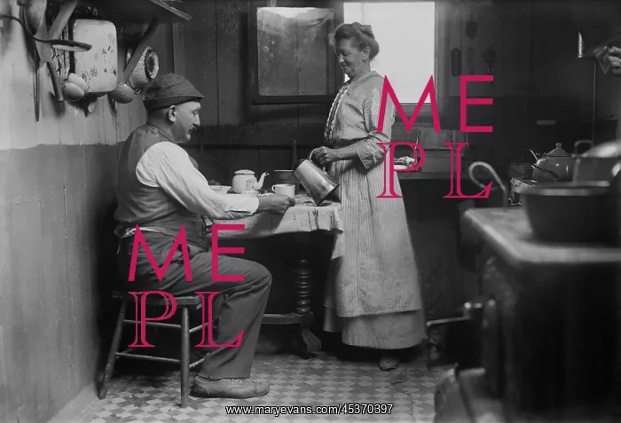 : Woman pouring a cup of coffee for a man at : Woman pouring a cup of coffee for a man at