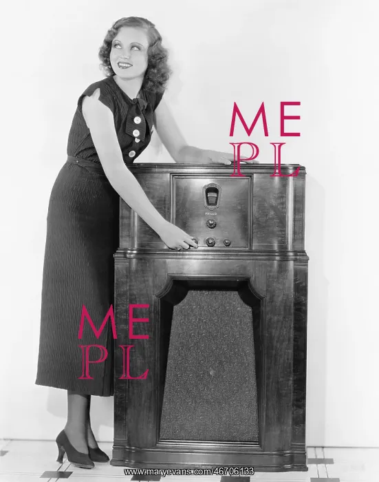 : Woman next to a radio turning the knobs : Woman next to a radio turning the knobs