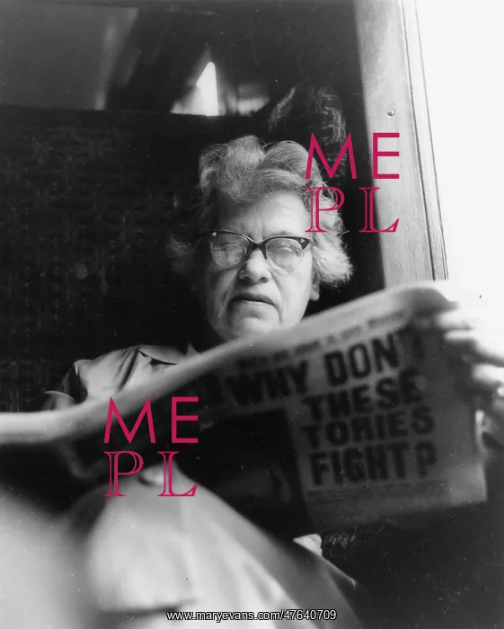 : Woman reading a newspaper on a train : Woman reading a newspaper on a train