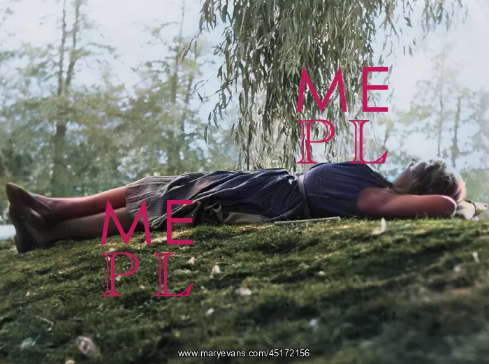  : Woman relaxing on grass under a tree