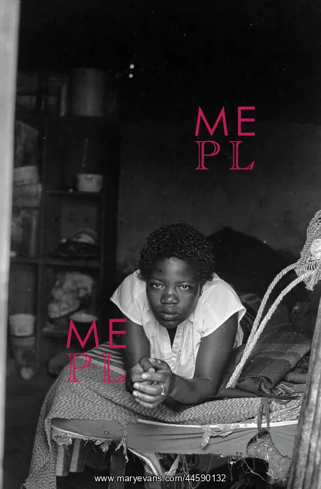 : A woman rests on her bed in Muldersdrift squatter : A woman rests on her bed in Muldersdrift squatter