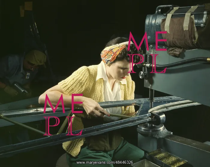 : A woman riveting machine operator at an aircraft : A woman riveting machine operator at an aircraft