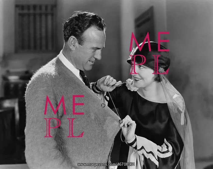 : Woman sewing the jumper of a man : Woman sewing the jumper of a man
