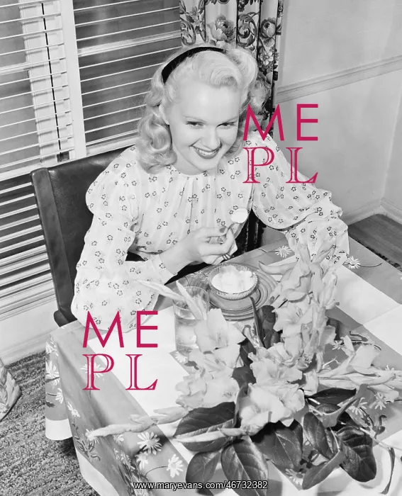 : Woman sitting at a breakfast table : Woman sitting at a breakfast table