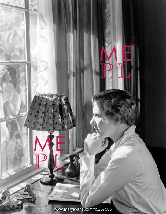: Woman sitting at a desk and looking through a window : Woman sitting at a desk and looking through a window
