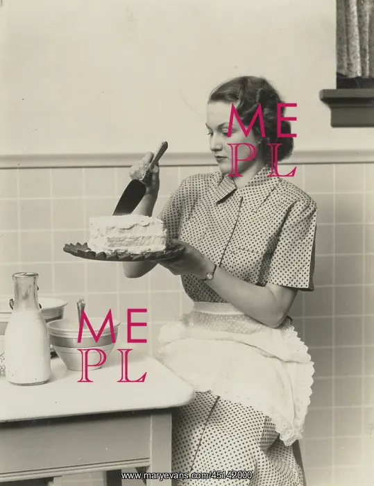 : Woman Sitting in Kitchen Wearing Apron Concentrating : Woman Sitting in Kitchen Wearing Apron Concentrating