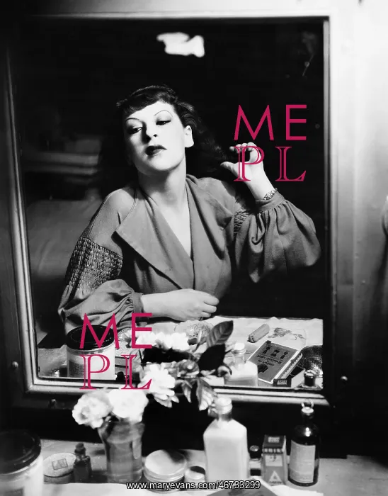: Woman sitting in front of her vanity looking into : Woman sitting in front of her vanity looking into