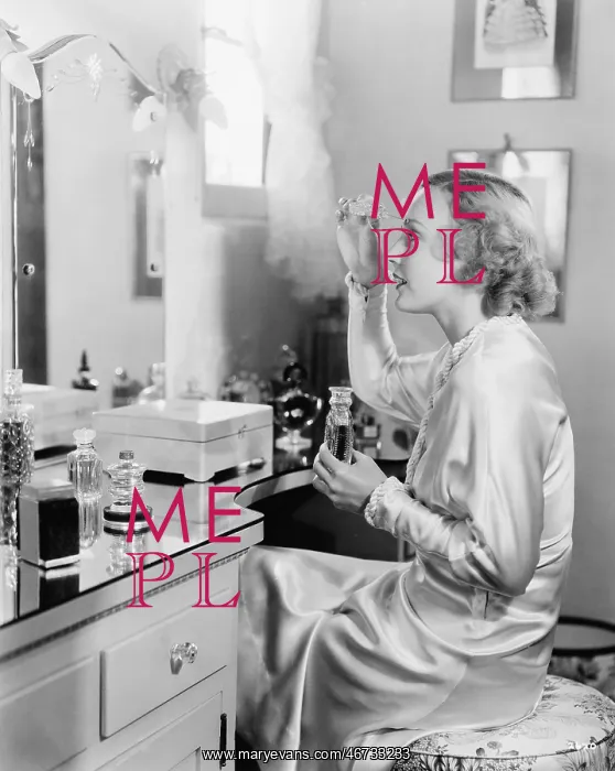 : Woman sitting in front of her vanity putting perfume : Woman sitting in front of her vanity putting perfume