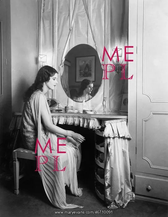 : Woman sitting at her vanity table : Woman sitting at her vanity table