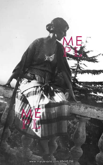  : A woman sitting on a wall
