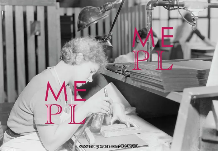 : Woman skillfully applying gold with an air : Woman skillfully applying gold with an air