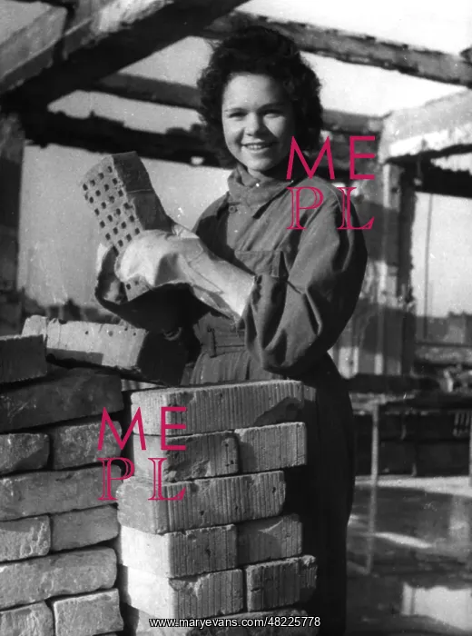 : Woman sorting bricks, 1944 : Woman sorting bricks, 1944