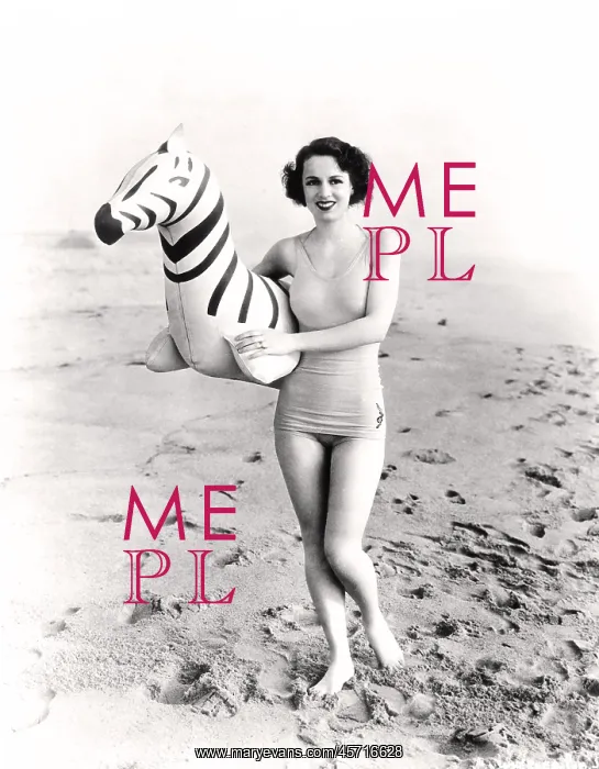 : Woman standing on beach with an inflatable zebra : Woman standing on beach with an inflatable zebra