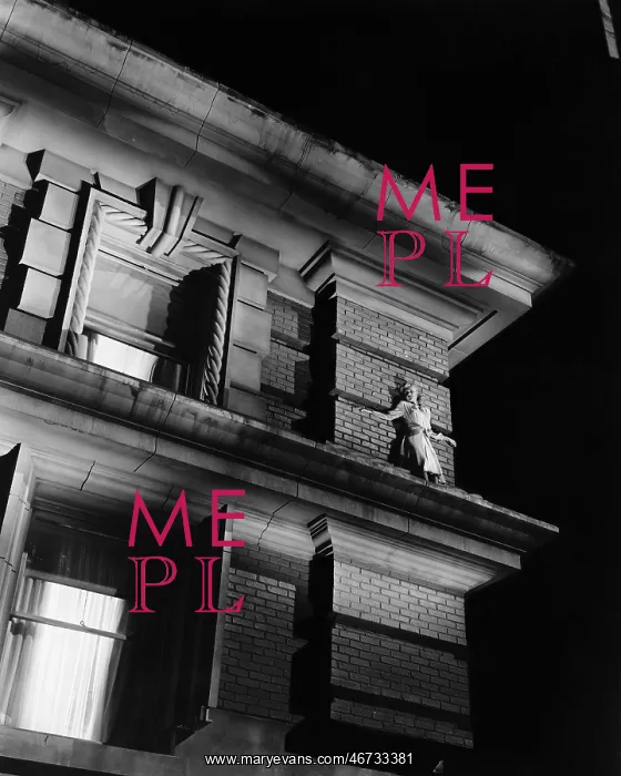 : Woman standing on the top of a building on a ledge : Woman standing on the top of a building on a ledge