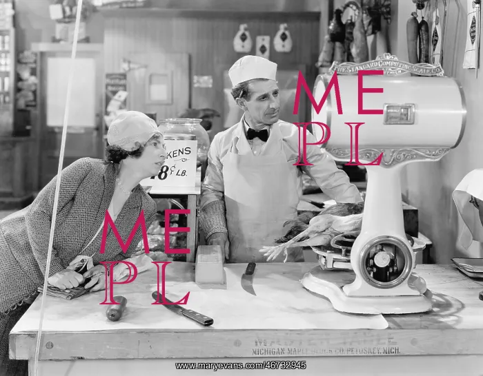 : Woman standing in a butcher store looking at the scale : Woman standing in a butcher store looking at the scale