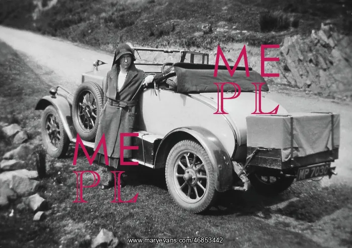 : Woman standing in front of car : Woman standing in front of car
