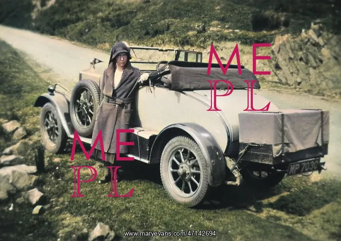 : Woman standing in front of car : Woman standing in front of car