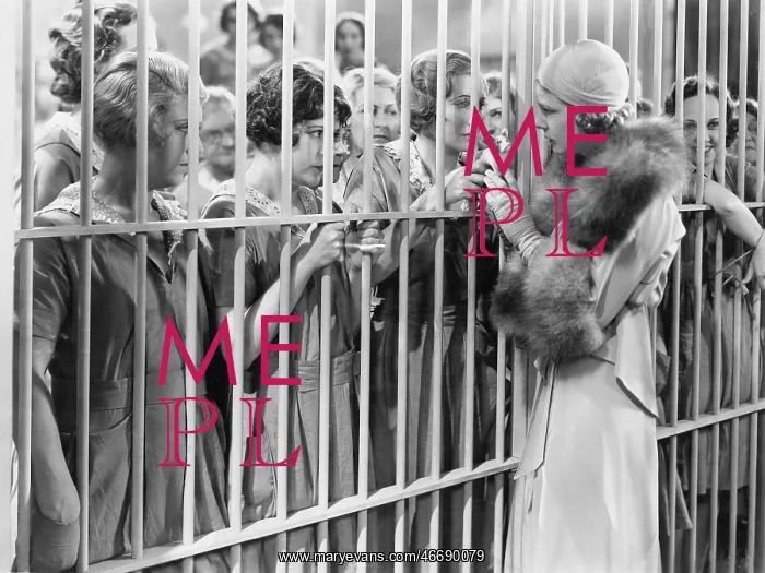 : One woman standing in front of a jail talking with : One woman standing in front of a jail talking with