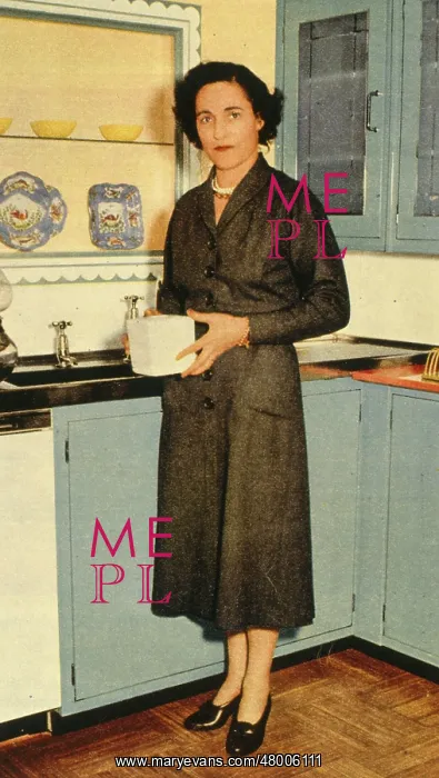 : Woman standing by her kitchen sink : Woman standing by her kitchen sink